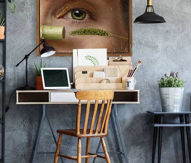 Close-up of a womans green eye with a bamboo stick and a weed stalk as a mascara tube and applicator	 by Artmood Visualz