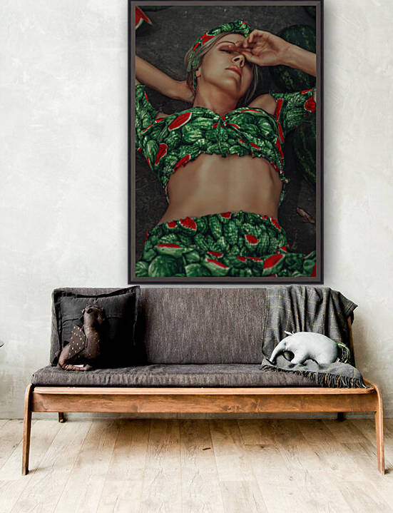Young attractive blonde woman wearing a green summer outfit with a watermelon pattern relaxing on a rocky ground while looking at the camera	 by Artmood Visualz
