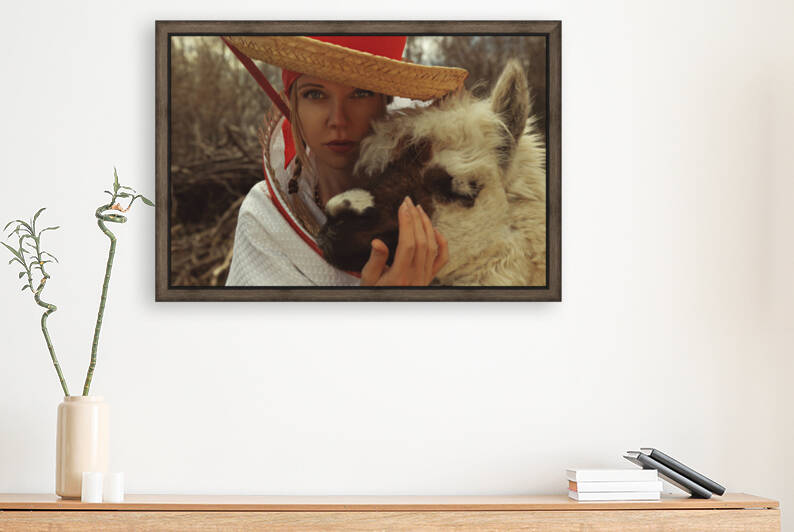 Portrait of a young blonde woman dressed in an outfit inspired by traditional South American costumes enjoying a day outdoors with an alpaca	 by Artmood Visualz