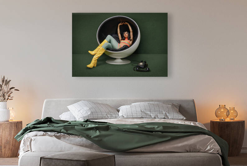 Young woman from the 60s sitting in a vintage ball chair her rotary dial telephone off the hook at her feet by Artmood Visualz