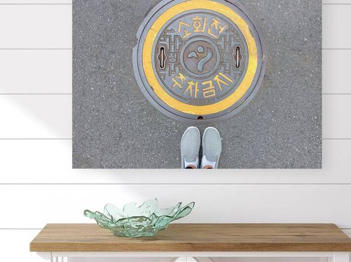 Manhole cover on sidewalk street in Seoul South Korea by Kevin Miller Photography
