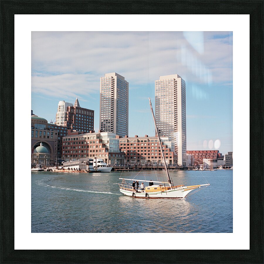 Sailboat floating by harbour with city skyline Picture Frame print
