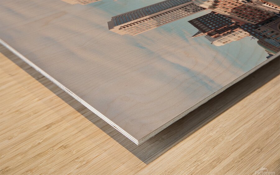 Sailboat floating by harbour with city skyline Wood print