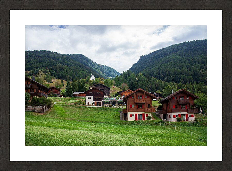 Charming houses dotting the Swiss Alps in Switzerland. Picture Frame print