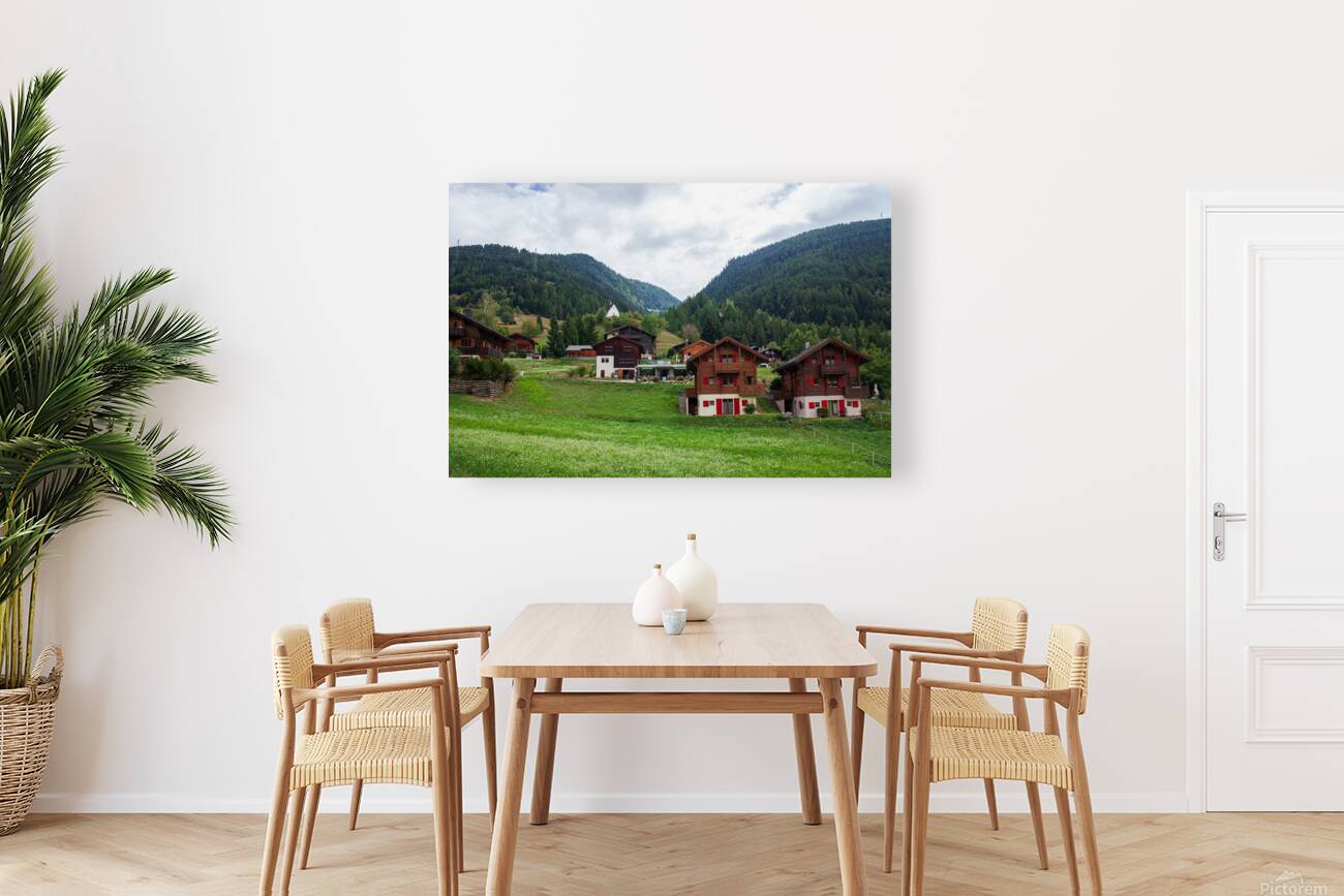 Charming houses dotting the Swiss Alps in Switzerland. Reproduction