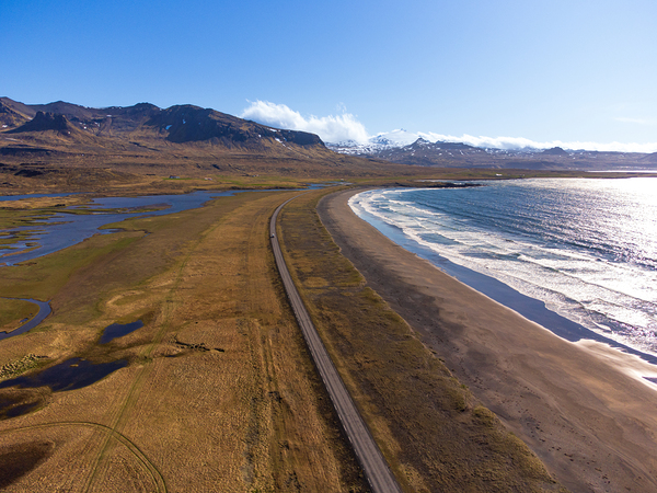 Iceland scenic route Snaefellsnes pensinsula volcano in the background covered in snow empty road with the ocean and waves. Digital Download