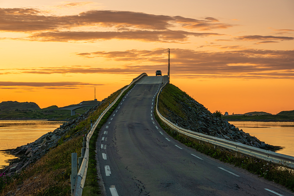 A car on the Fredvang bridges in Lofoten Norway with a beautiful sunset over the sea.  Digital Download