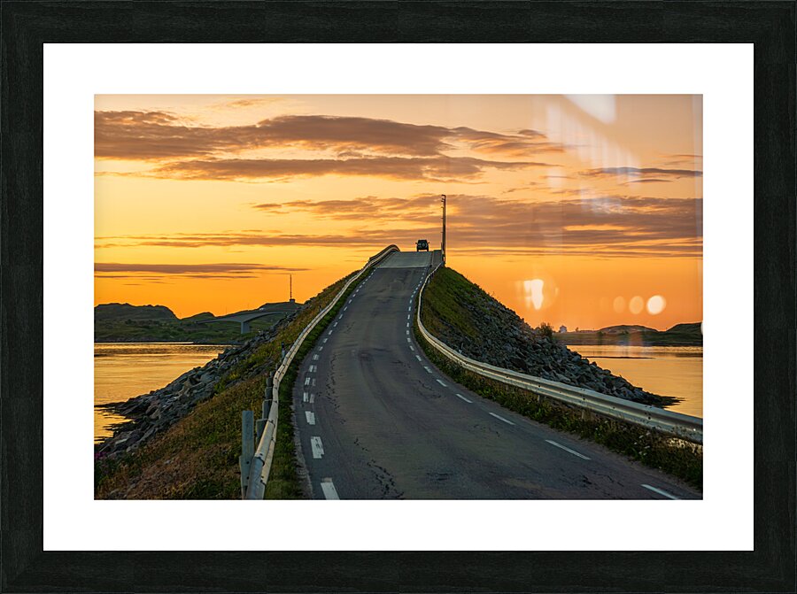 A car on the Fredvang bridges in Lofoten Norway with a beautiful sunset over the sea.  Picture Frame print