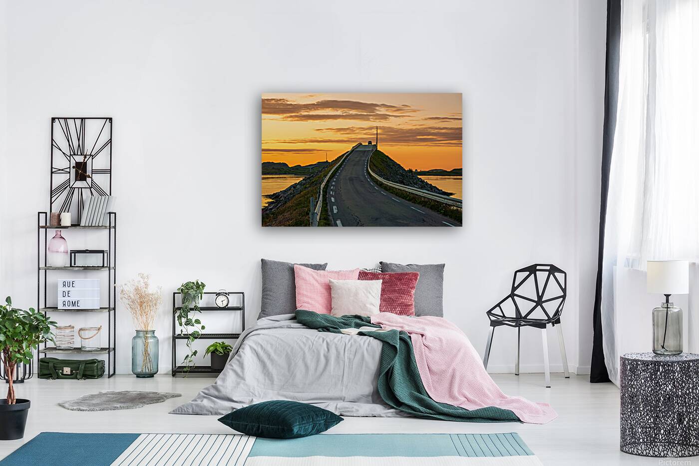 A car on the Fredvang bridges in Lofoten Norway with a beautiful sunset over the sea.  Reproduction