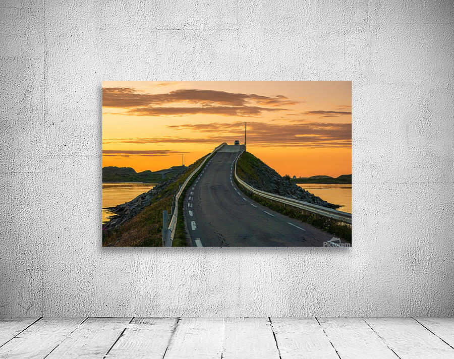A car on the Fredvang bridges in Lofoten Norway with a beautiful sunset over the sea.  Wall Preview