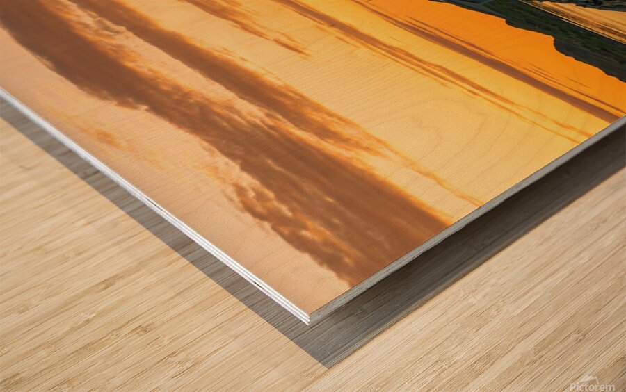 A car on the Fredvang bridges in Lofoten Norway with a beautiful sunset over the sea.  Wood print