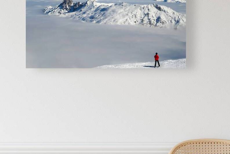 Beyond the clouds skier and the Mont Blanc in the Alps by DELPHIMAGES