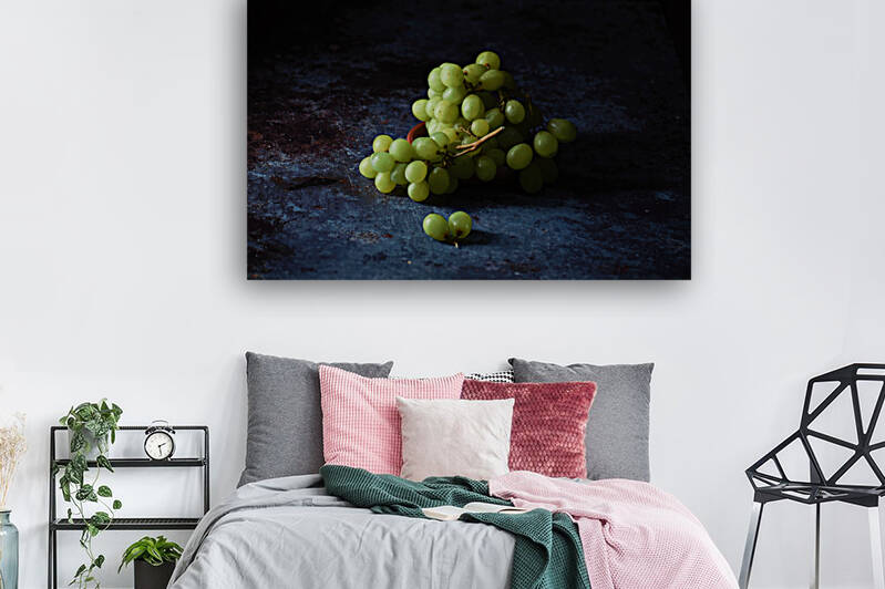 Green grapes on dark table against black background by Thevectoryfloor