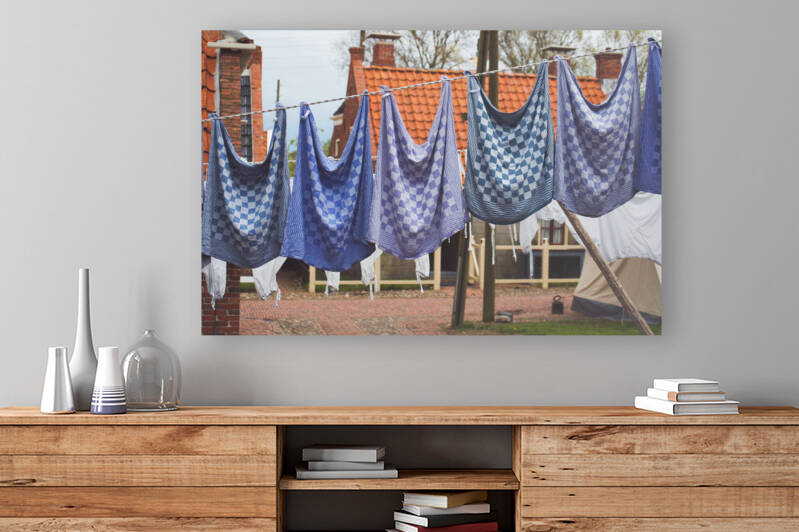 Close-up of traditional gingham dish cloths on clothesline in historical Dutch town of Enkhuizen by Thevectoryfloor