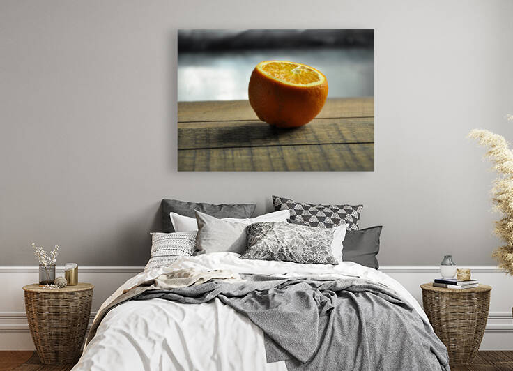 Close-up of halved orange on wooden table by Thevectoryfloor