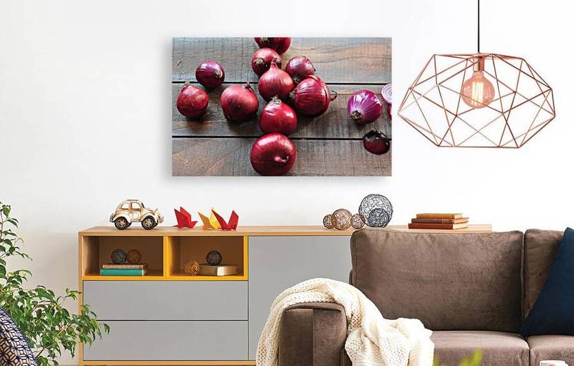High angle view of red onions on wooden table by Thevectoryfloor