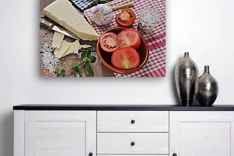 High angle view of garlic tomatoes and parmesan cheese on plaid cloth by Thevectoryfloor