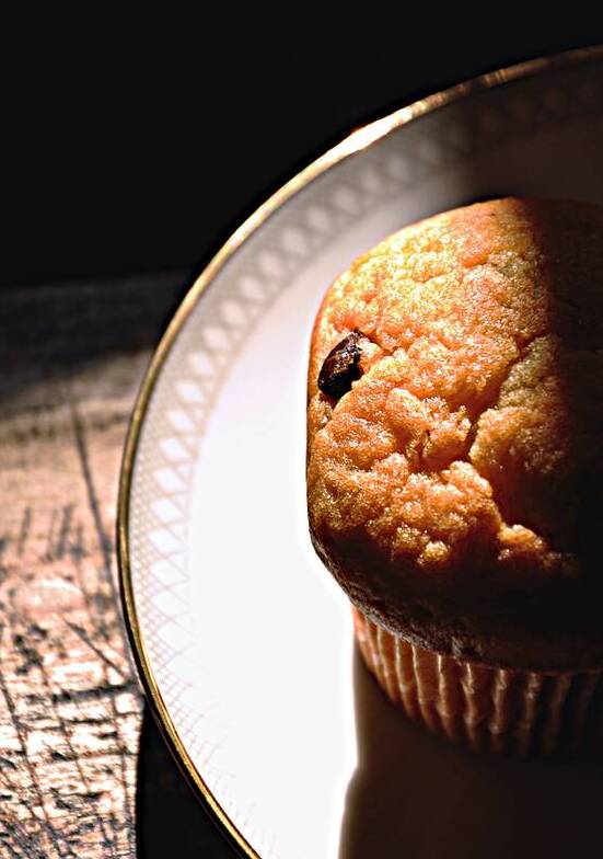 Close-up of muffin on plate on black background by Thevectoryfloor