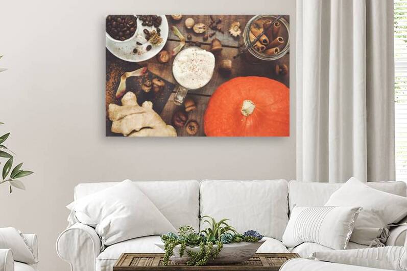 Directly above shot of pumpkin spice latte in glass jar on table next to pumpkins cookies spices and roasted coffee beans by Thevectoryfloor