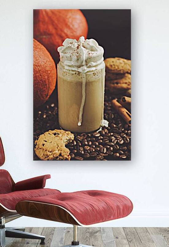Close-up of pumpkin spice latte in glass jar on table next to pumpkins cookies and roasted coffee beans by Thevectoryfloor