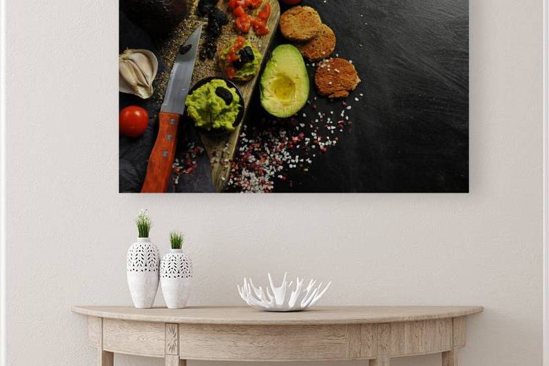 Directly above shot of guacamole ingredients next to toast on black background by Thevectoryfloor