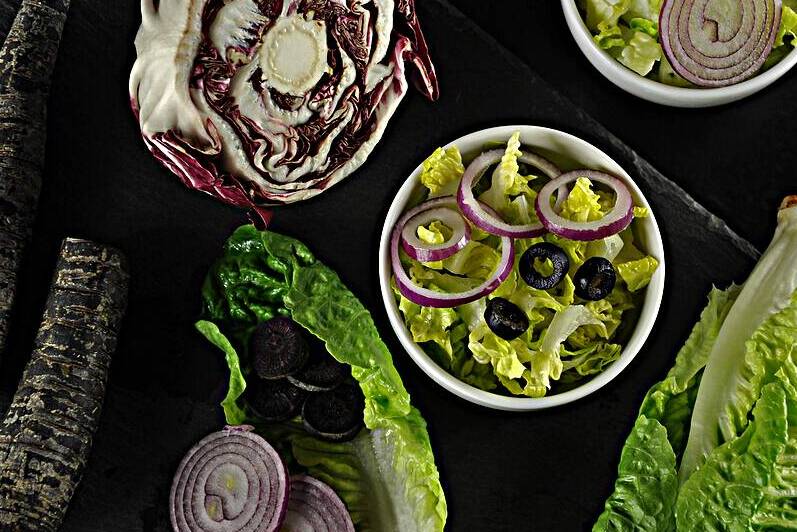 Directly above shot of multi colored vegetables on black background by Thevectoryfloor