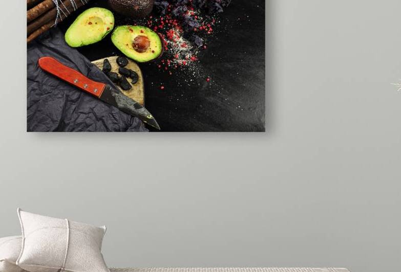 High angle view of avocado and yuca roots on cutting board on black background by Thevectoryfloor