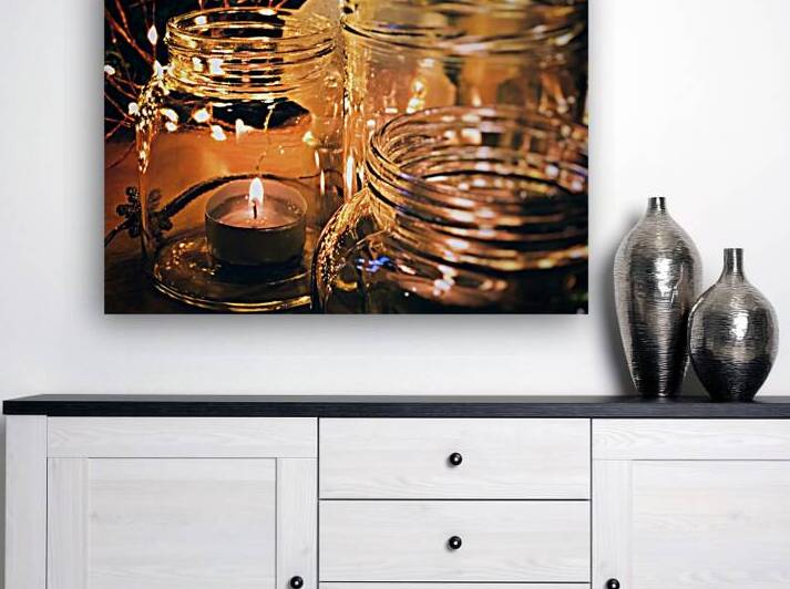 Close-up of burning candle in glass jar by Thevectoryfloor