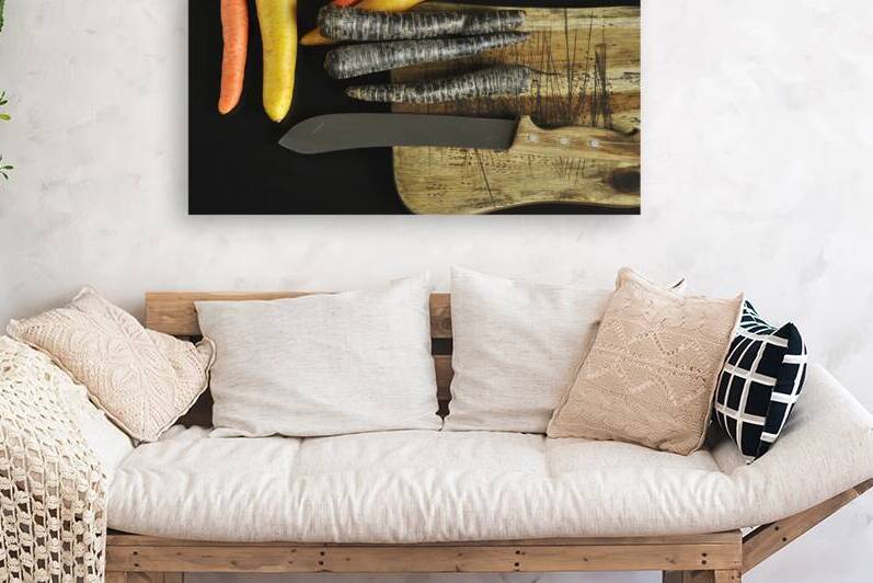 Directly above shot of multi colored carrots and kitchen knife on cutting board on black background by Thevectoryfloor