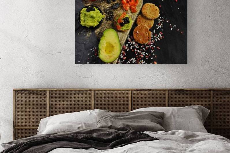 Directly above shot of guacamole ingredients next to toast on black background by Thevectoryfloor