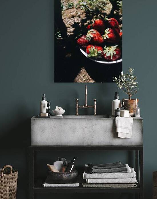 Close-up of fresh strawberries in bowl on stone table during picnic by Thevectoryfloor