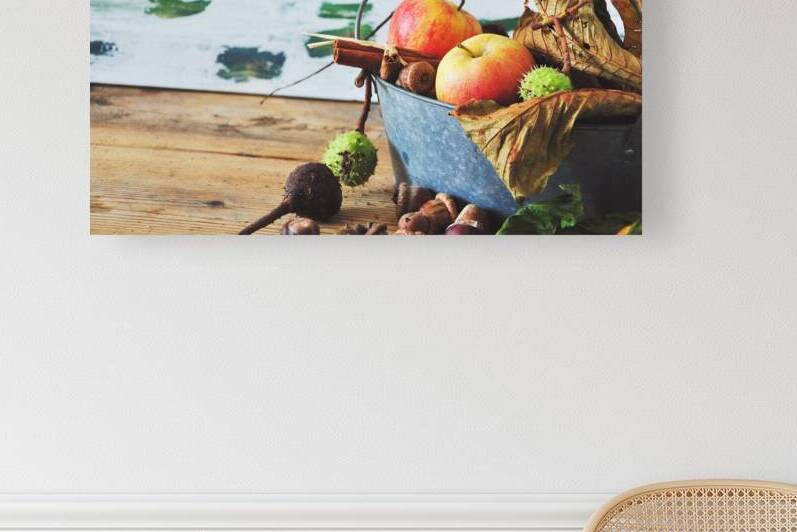 Close-up of apples and autumn decorations on wooden table by Thevectoryfloor