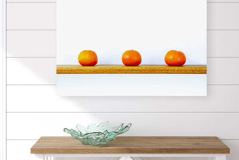 Three Oranges on a Shelf by Nathan Bickel