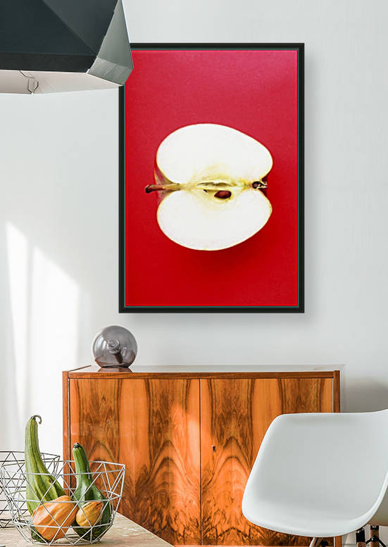 Half An Apple On Red Background by PacificStock