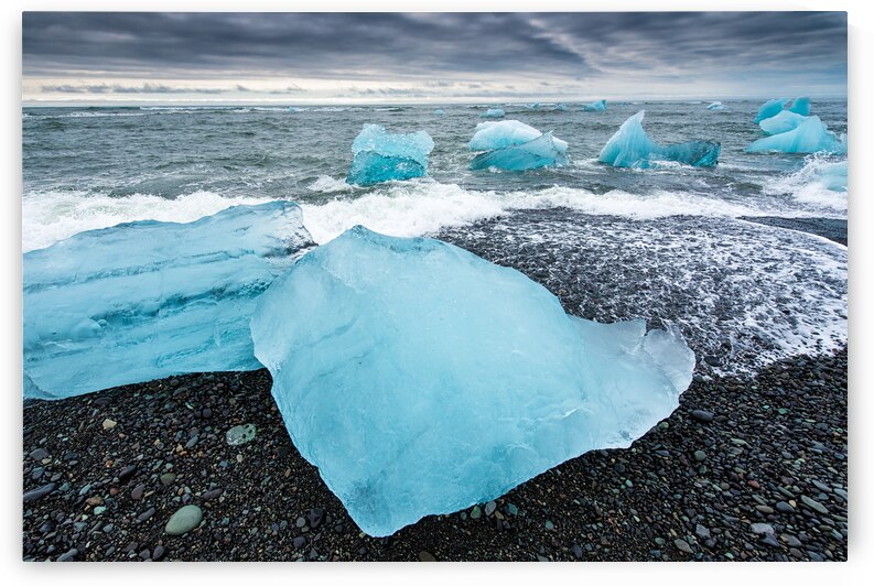 Cool blue glacier ice on black beach in Iceland by Matthias Hauser