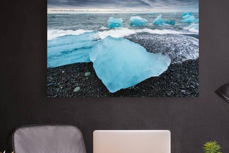 Cool blue glacier ice on black beach in Iceland by Matthias Hauser
