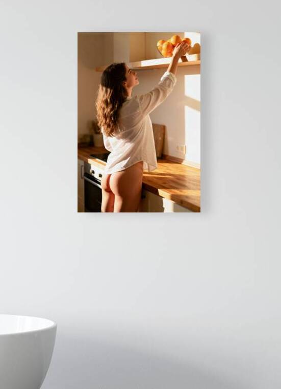 Woman Reaching for Oranges in Sunlit Kitchen by Matthias Hauser
