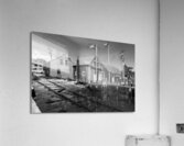 Black and white shot of historic harbour buildings and boat ramp on Cape Cod in New England  Acrylic Print