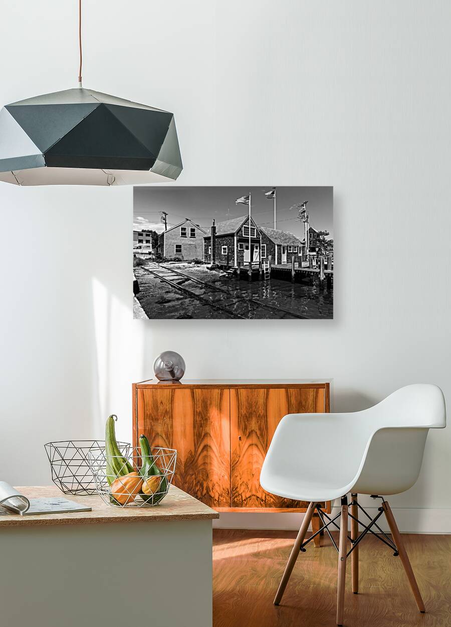 Black and white shot of historic harbour buildings and boat ramp on Cape Cod in New England  Reproduction