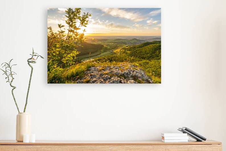 Beautiful sunset over a rock ledge Wackerstein in the Swabian Alps in Southern Germany by caladoart