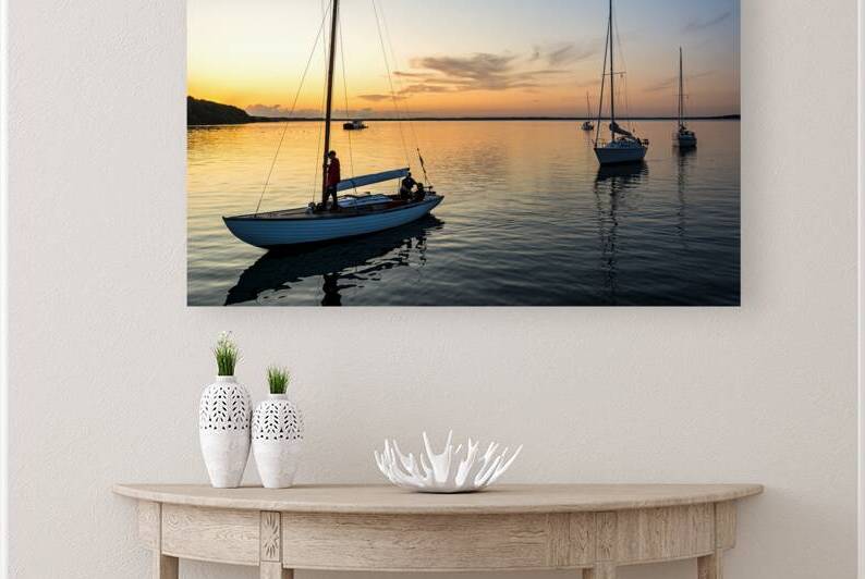 Sailing boats coming back into the harbour during scenic sunset at the Baltic Sea in Northern Germany by caladoart