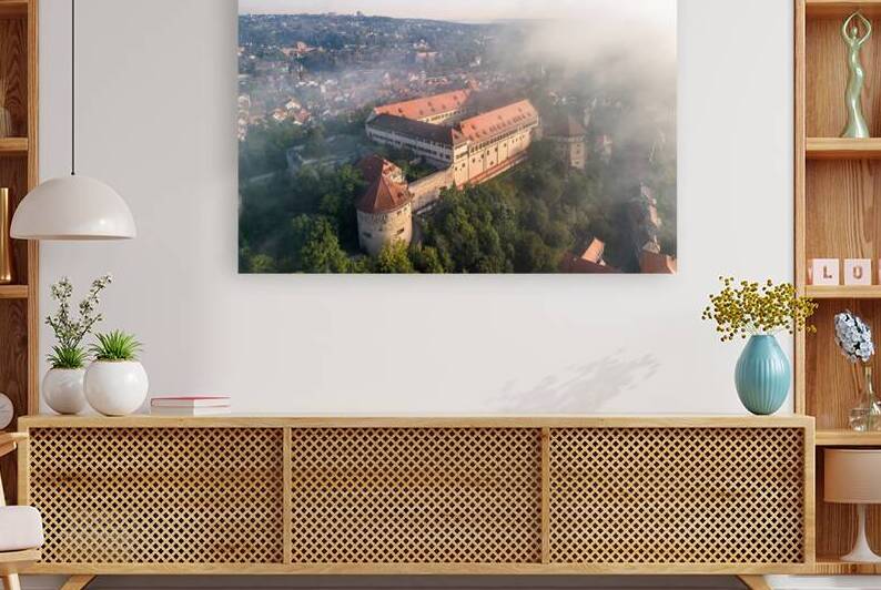 Close aerial view of the historic castle of Hohentübingen in the city of Tübingen in the morning fog by caladoart