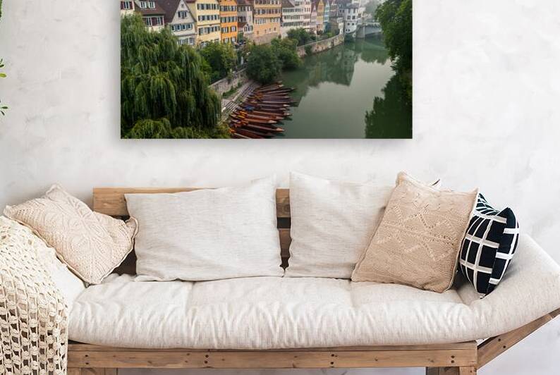 Traditional punt boats Stocherkahn in front of picturesque buildings at the waterfront of Tübingen in the morning fog  by caladoart