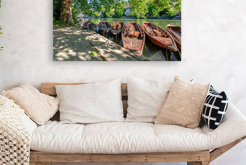 Historic punt boats Stocherkahn at a pier at the Neckar River in Tübingen Germany by caladoart