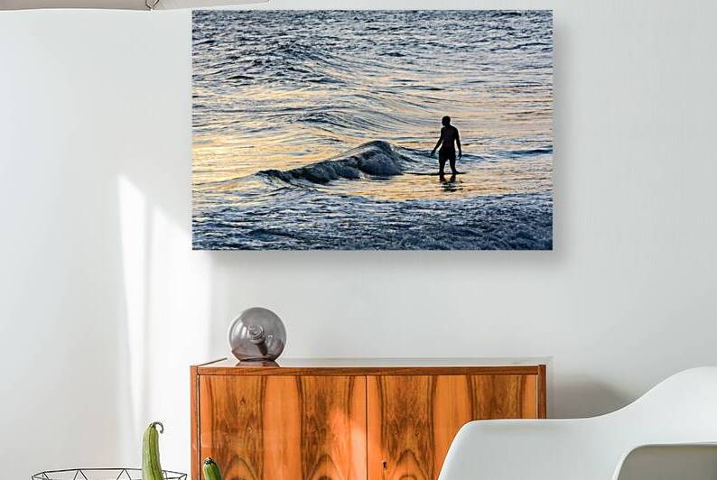 Lonely man standing in the surf at Ipanema Beach in Rio de Janeiro in Brazil at sunset   by caladoart