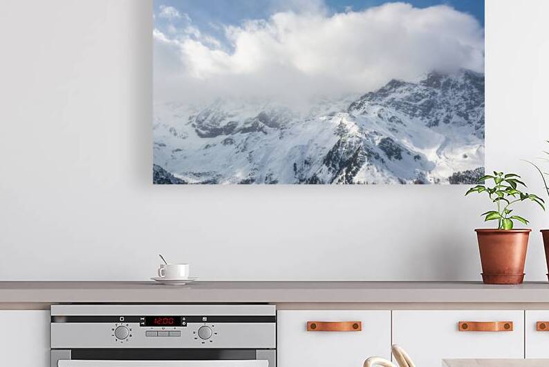 Clouds over mountain range in the European Alps in winter  by caladoart