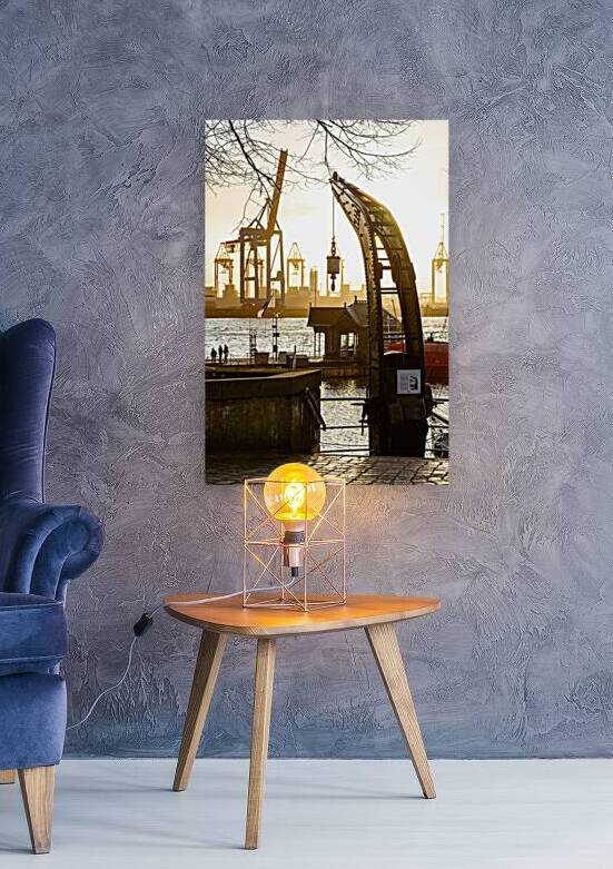 Historic crane at the historic harbor in Hamburg Övelgönne at the Elbe River at sunset by caladoart