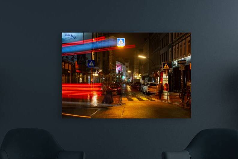 Long exposure night shot of a colourfully lit up street and zebra crossing in Hamburg Altona by caladoart