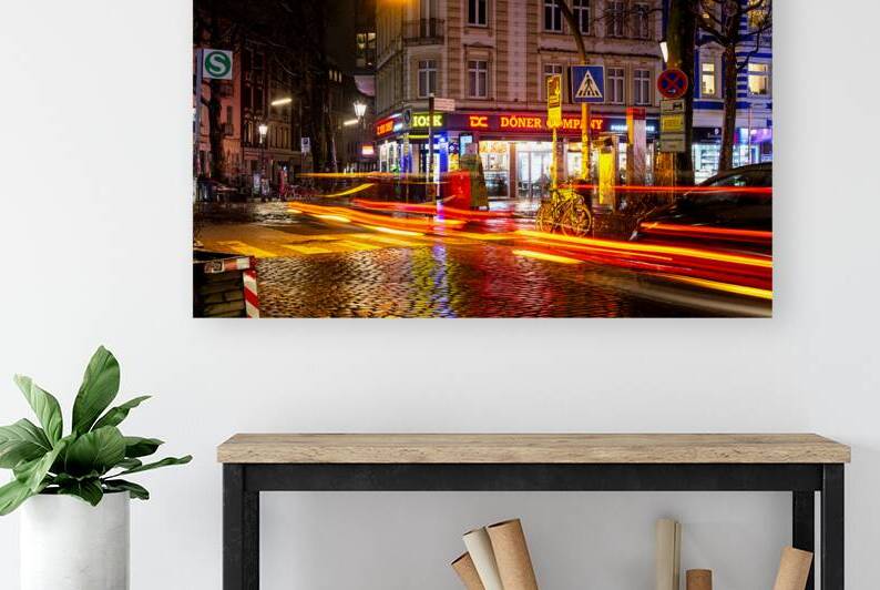 Long exposure night shot of a colourfully illuminated street corner and zebra crossing in Hamburg Altona by caladoart