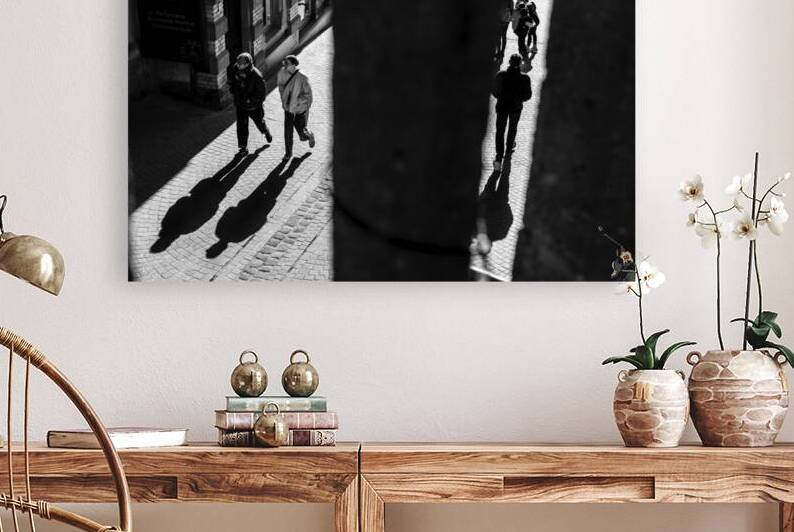 Black and white shot of people walking down a pedestrian street seen through a fence by caladoart